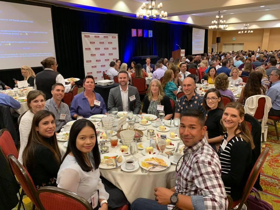 A table of team members smiling at the camera